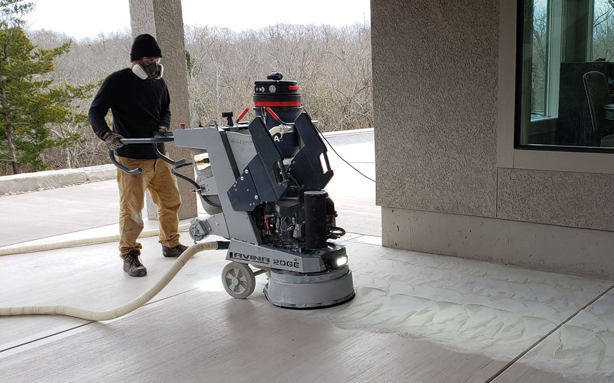 a professional preparing a concrete floor for coating