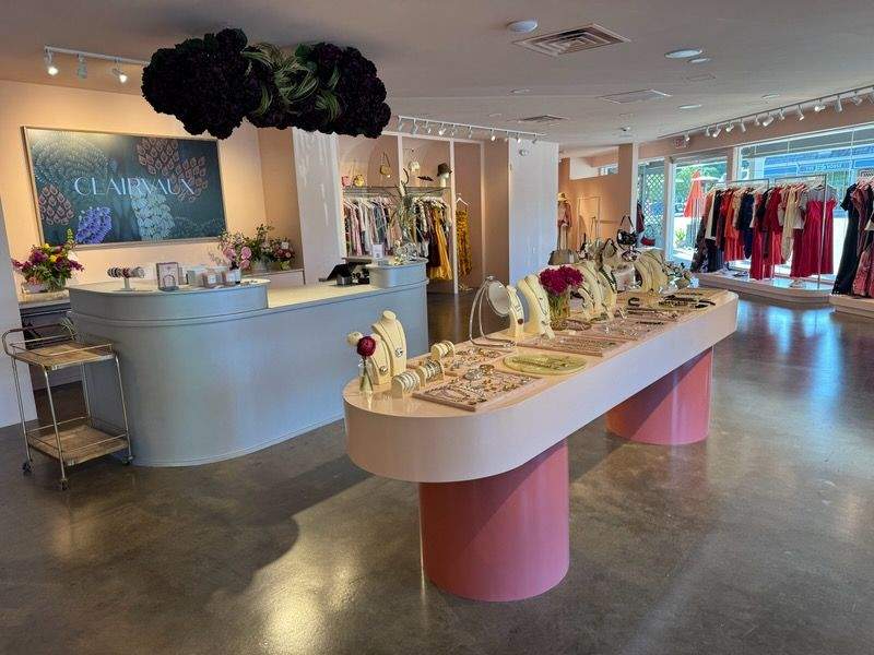 Commercial Epoxy Floor Retail Dark gray polished epoxy-coated commercial floor with glossy wet finish in boutique retail space with white curved counters